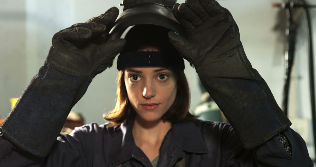 Woman Preparing for Welding in Workshop - Free Images, Stock Photos and Pictures on Pikwizard.com