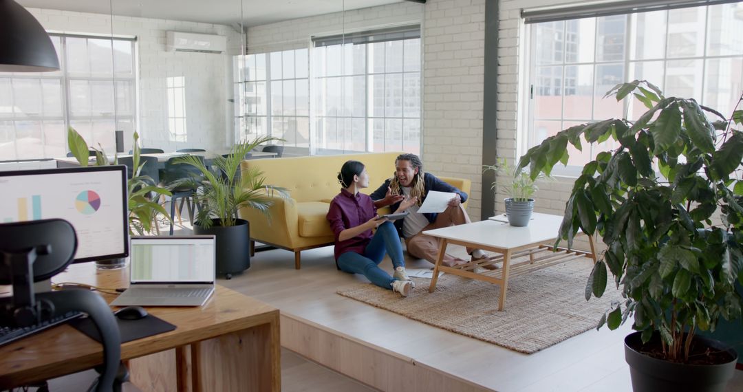 Diverse Colleagues Collaborating on Floor in Modern Office