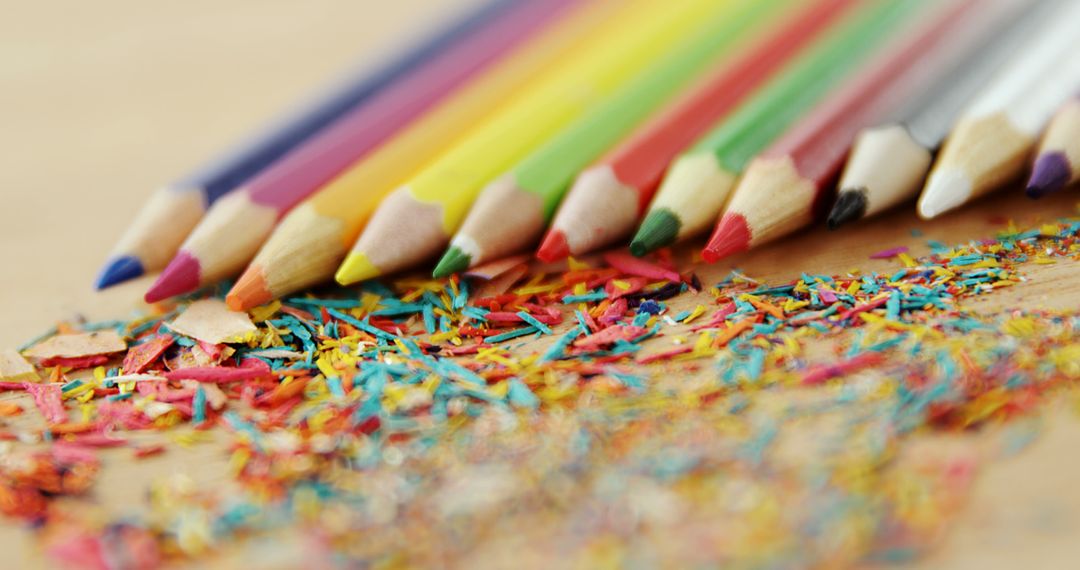 Colorful Pencils and Shavings on Wooden Surface - Free Images, Stock Photos and Pictures on Pikwizard.com