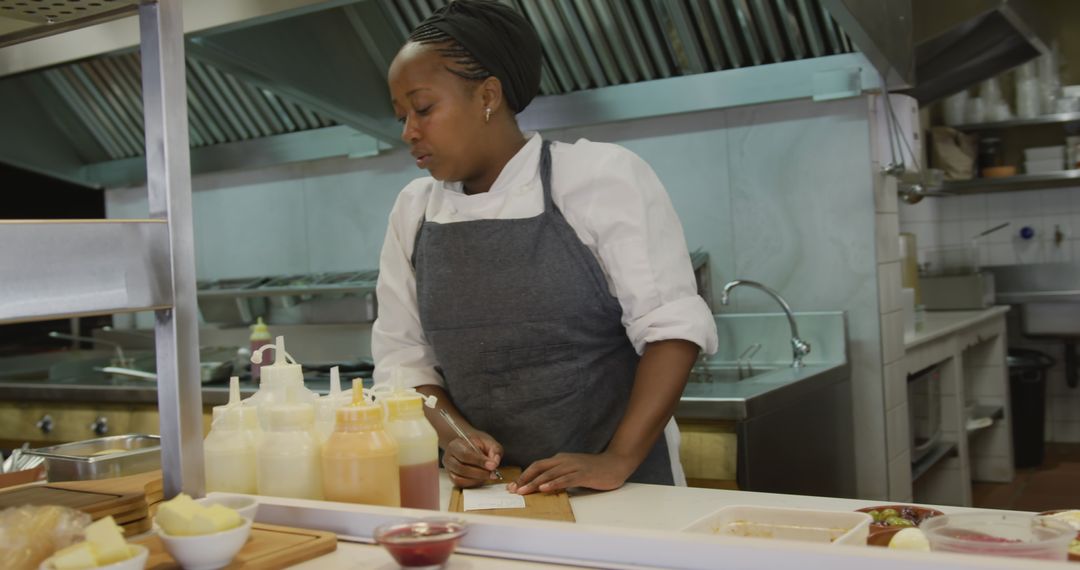 Focused Chef Writing Shopping List in Professional Kitchen