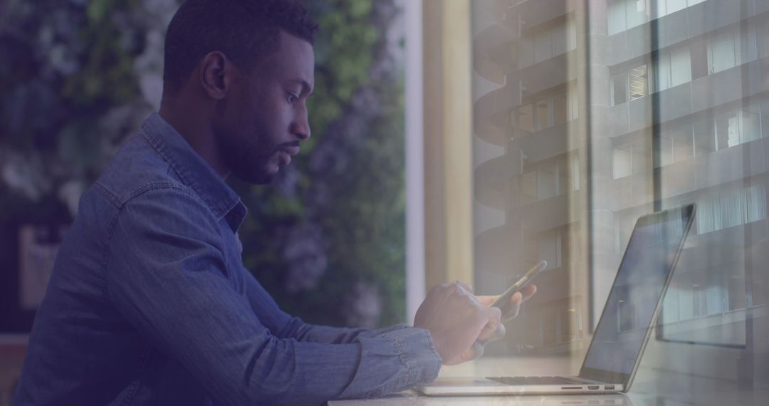 Businessman Working on Laptop with Digital Data Overlay