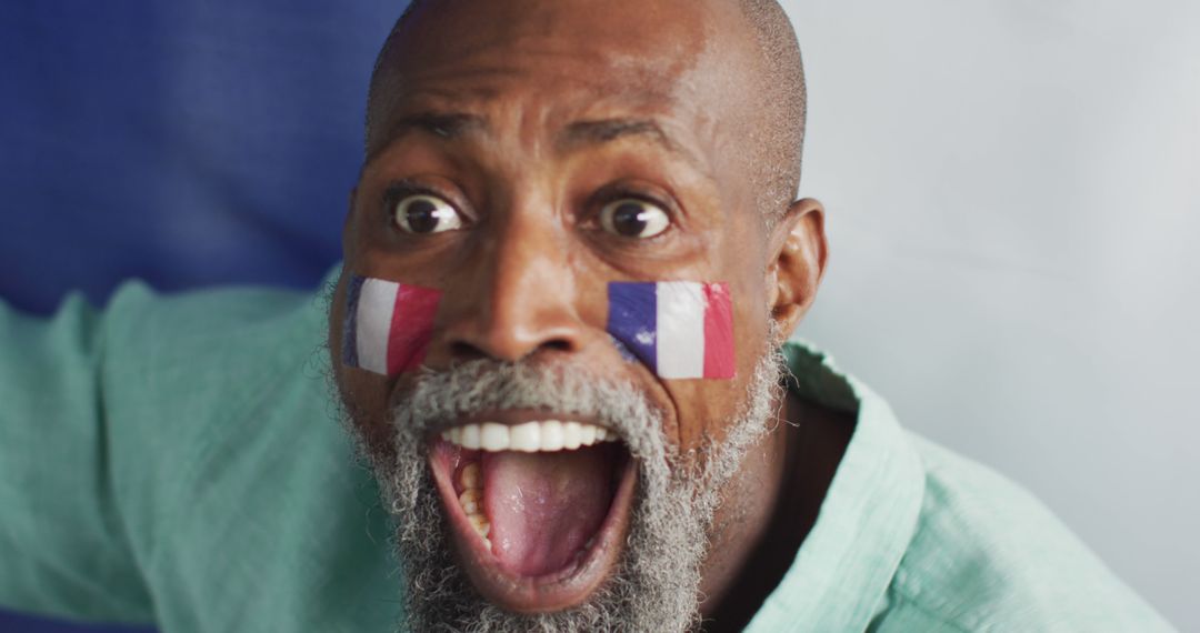 Image of happy african american man with flags watching match in tv - Free Images, Stock Photos and Pictures on Pikwizard.com