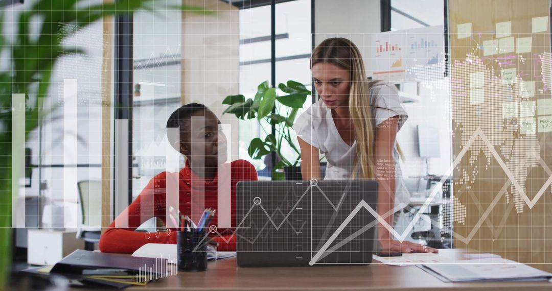Diverse Female Colleagues Analyzing Data with Digital Diagrams