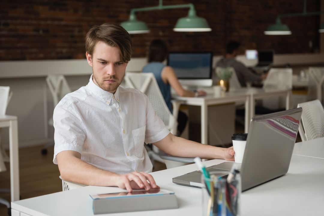 Focused Businessman Working on Tablet in Office Environment