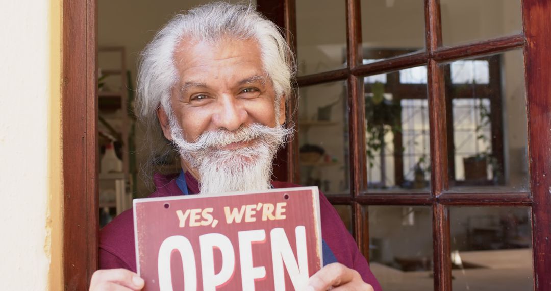 Smiling Shop Owner Displaying Open Sign at Store Entrance - Free Images, Stock Photos and Pictures on Pikwizard.com