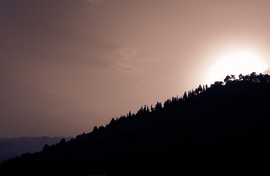 Scenic Sunset Over Tree-Lined Mountain Silhouette - Free Images, Stock Photos and Pictures on Pikwizard.com