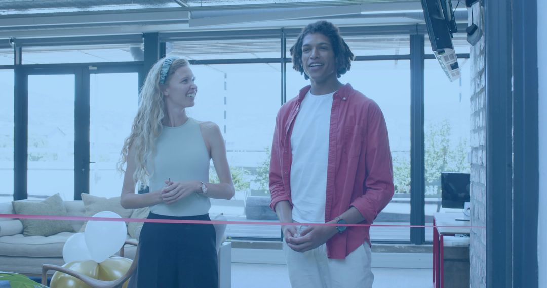 Young Hosts Conducting Ribbon Cutting Ceremony in Sunlit Contemporary Minimalist Lounge