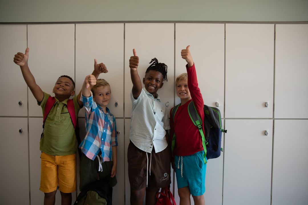 Multiracial schoolboys give thumbs up by lockers - Free Images, Stock Photos and Pictures on Pikwizard.com