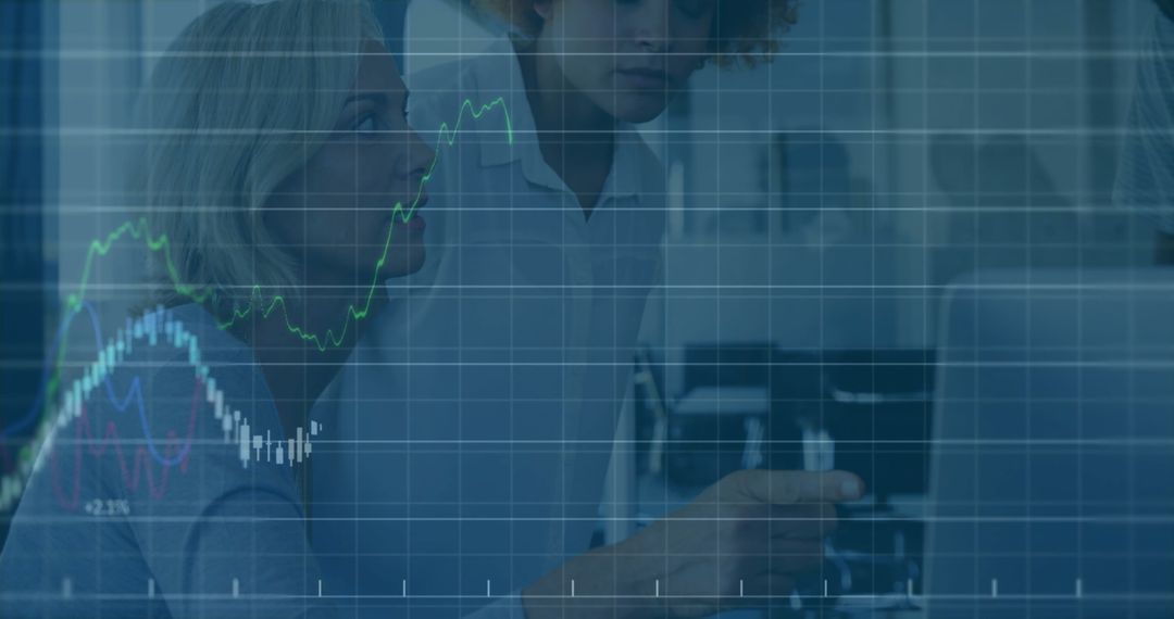 Diverse Business Team Analyzing Financial Trends on Digital Screens