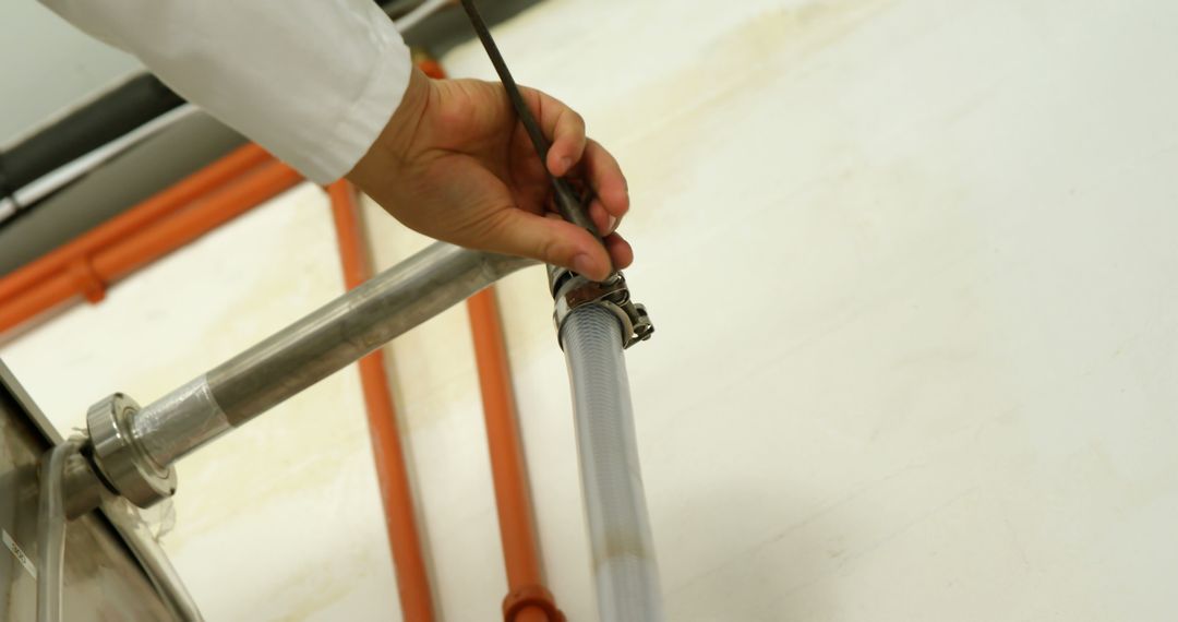 Technician hands adjusting industrial pipe system with wrench - Free Images, Stock Photos and Pictures on Pikwizard.com