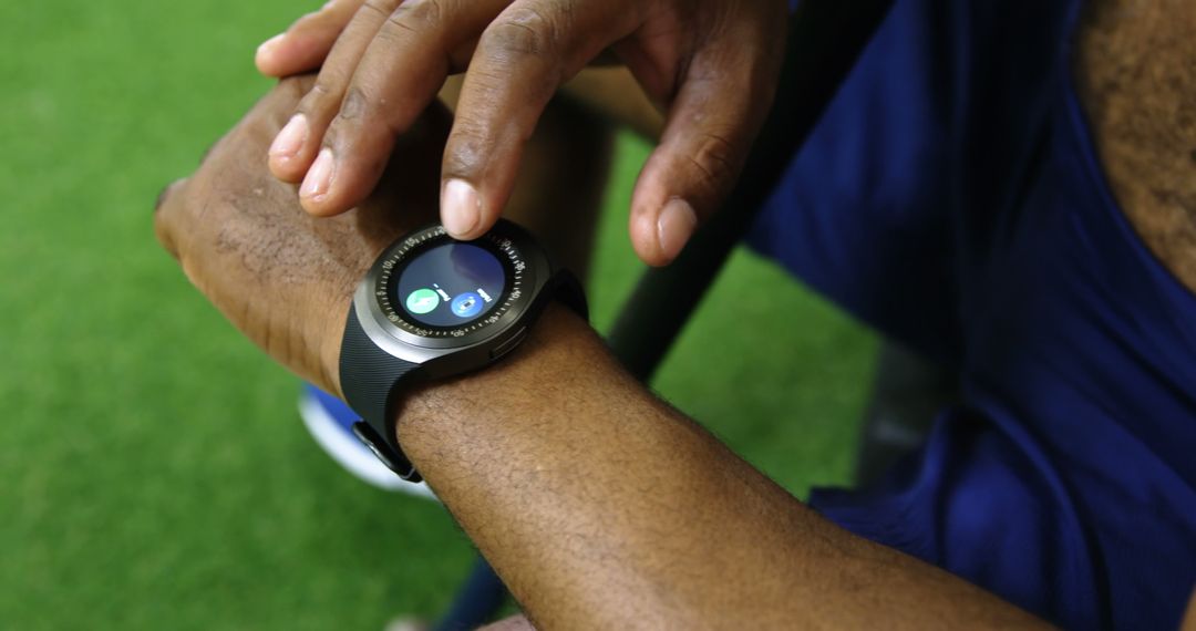 Person Using Smartwatch with Fitness Tracking Outdoors - Free Images, Stock Photos and Pictures on Pikwizard.com