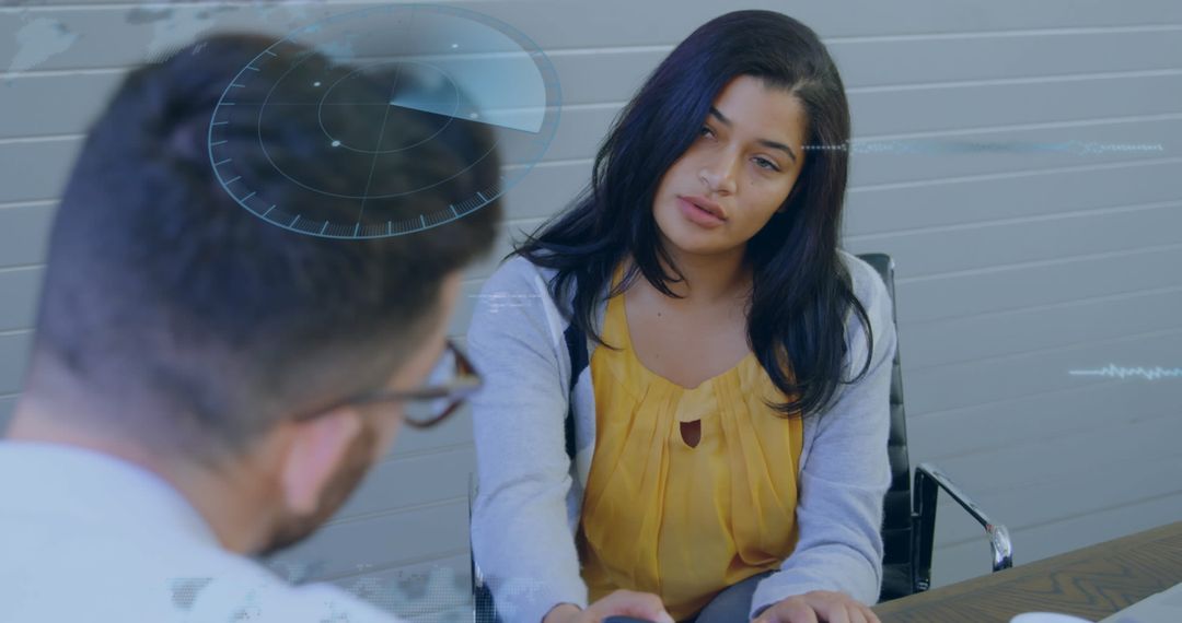 Two Colleagues Using Advanced Analytics in Office Discussion