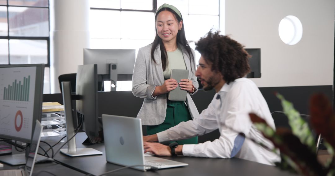Business Colleagues Collaborating on Office Project with Laptops