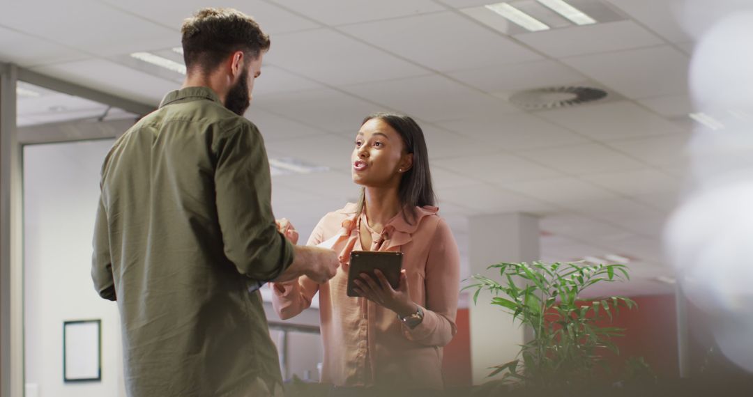 Diverse Business Team Discussing Work Details in Modern Office