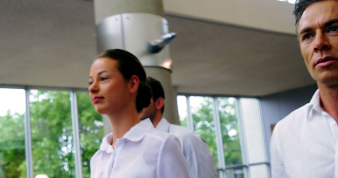 Focused Professionals Walking in Open Office Environment