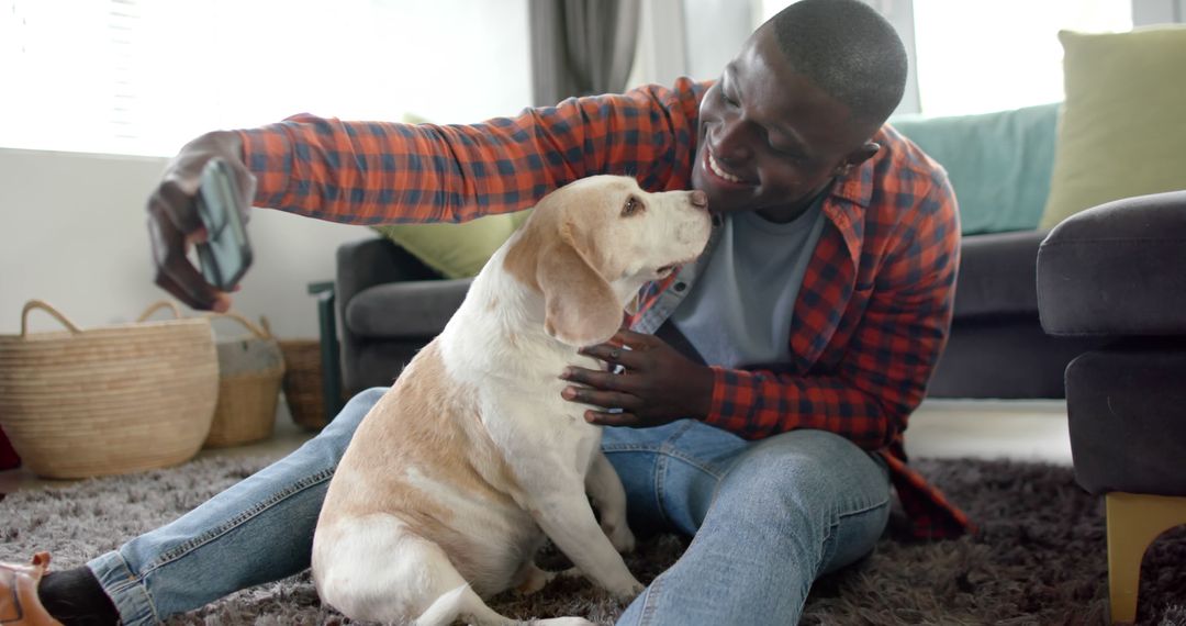 Smiling African American Man Taking Selfie with Adorable Beagle at Home - Free Images, Stock Photos and Pictures on Pikwizard.com