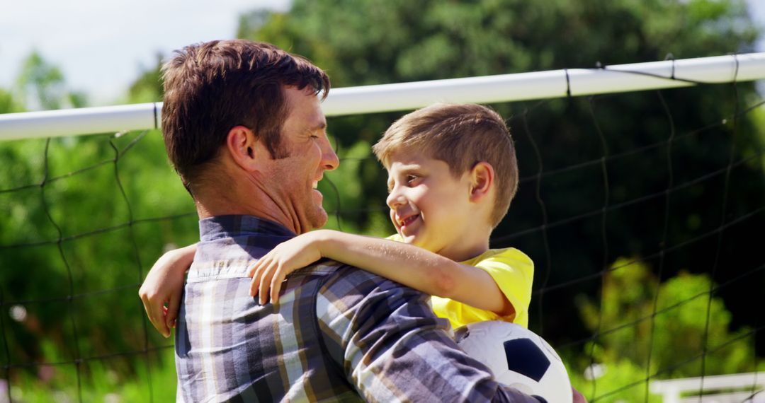 Father and Son Bonding While Playing Soccer Outdoors - Free Images, Stock Photos and Pictures on Pikwizard.com