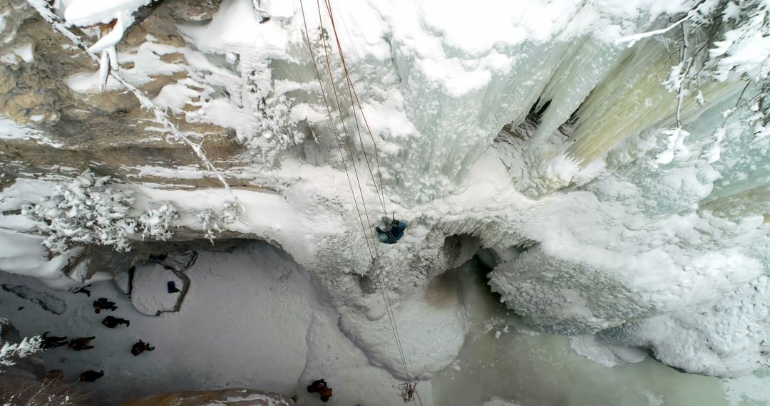 Adventurous Ice Climber Scaling Frozen Waterfall in Winter, Aerial View - Free Images, Stock Photos and Pictures on Pikwizard.com