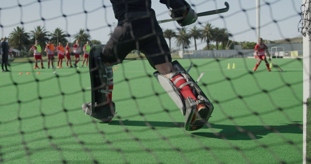 Field Hockey Goalie Practicing Save as Team Looks On - Free Images, Stock Photos and Pictures on Pikwizard.com