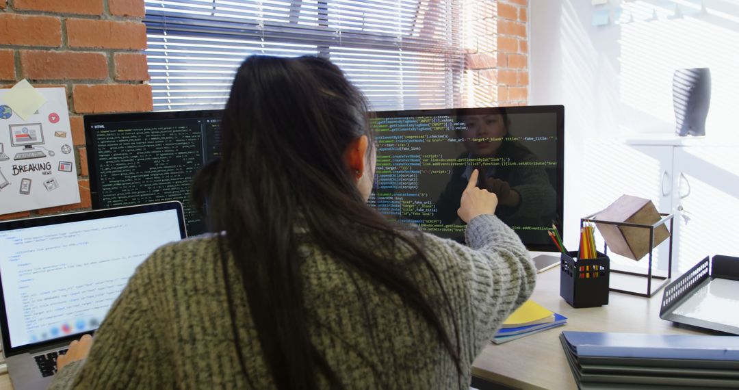 Businesswoman Analyzing Code on Computer in Modern Office Space - Free Images, Stock Photos and Pictures on Pikwizard.com