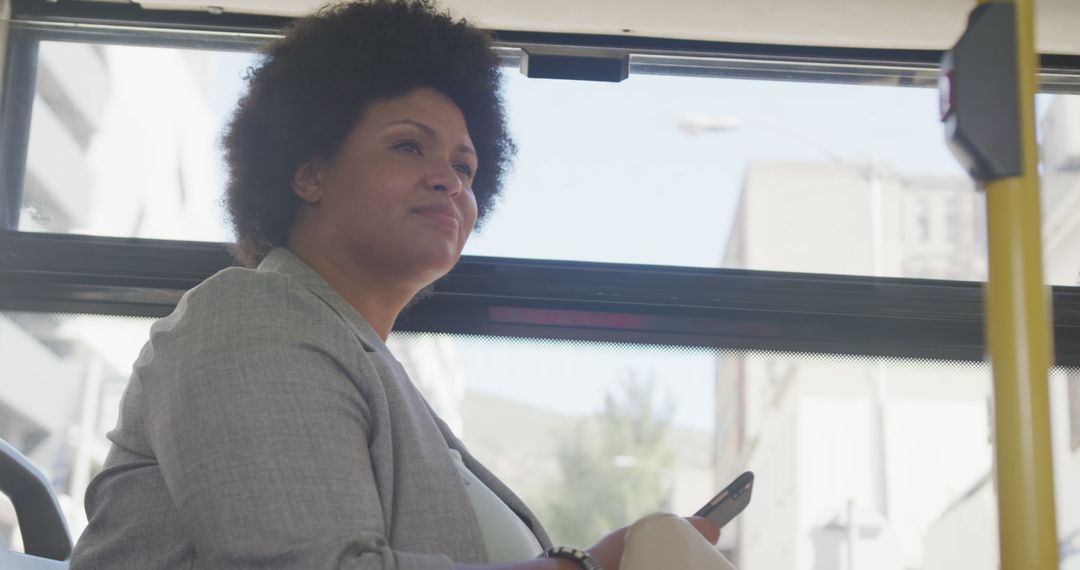 Confident Plus Size Biracial Woman on Bus Using Smartphone