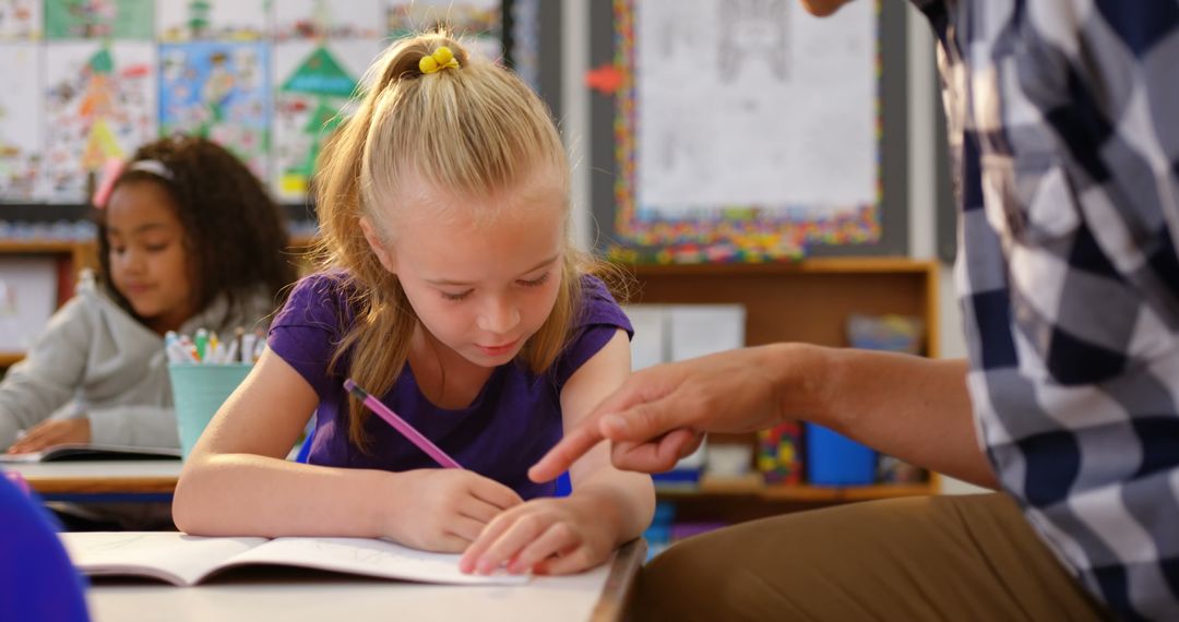 Teacher Guiding Young Student in Classroom Learning Environment