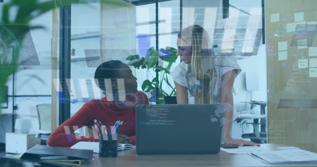 Diverse Female Coworkers Discussing Reports in Modern Office - Free Images, Stock Photos and Pictures on Pikwizard.com