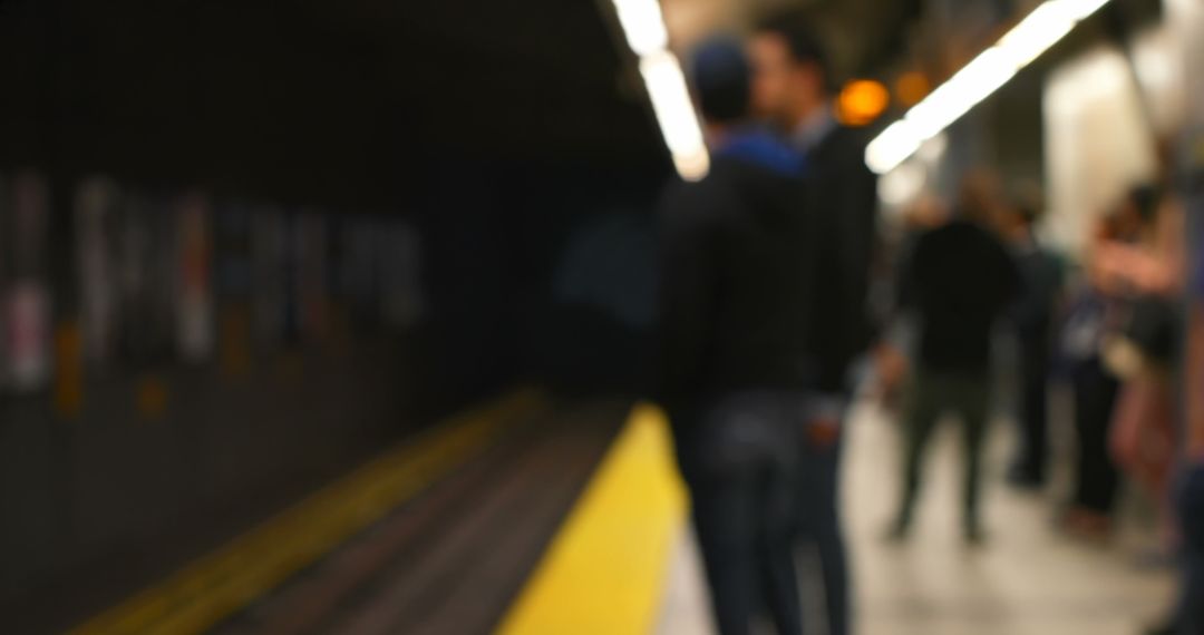 Defocused Commuters on Platform Awaiting Train Arrival