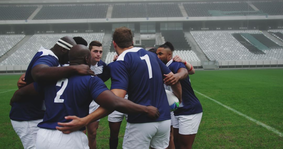 Rugby Team Huddle in Stadium Showing Unity and Strategy