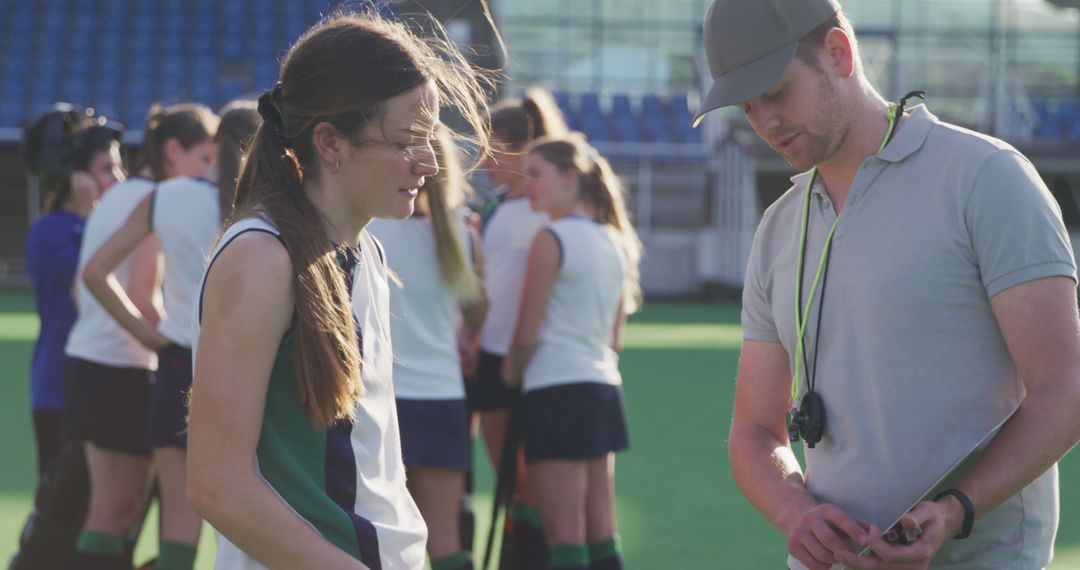 Field Hockey Coach Giving Instructions to Female Athlete - Free Images, Stock Photos and Pictures on Pikwizard.com