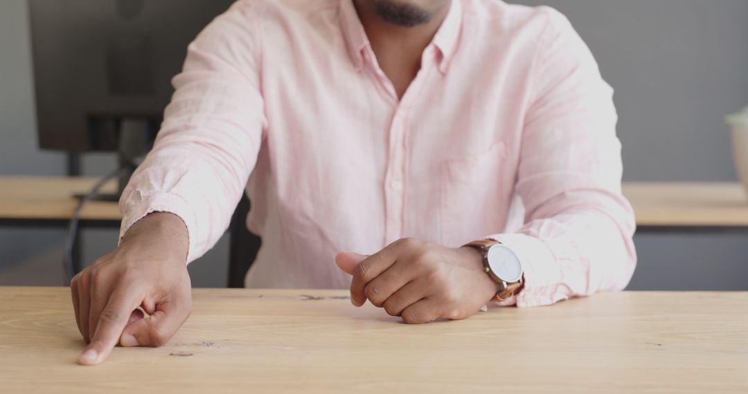 Businessman Pointing at Desk During Office Meeting