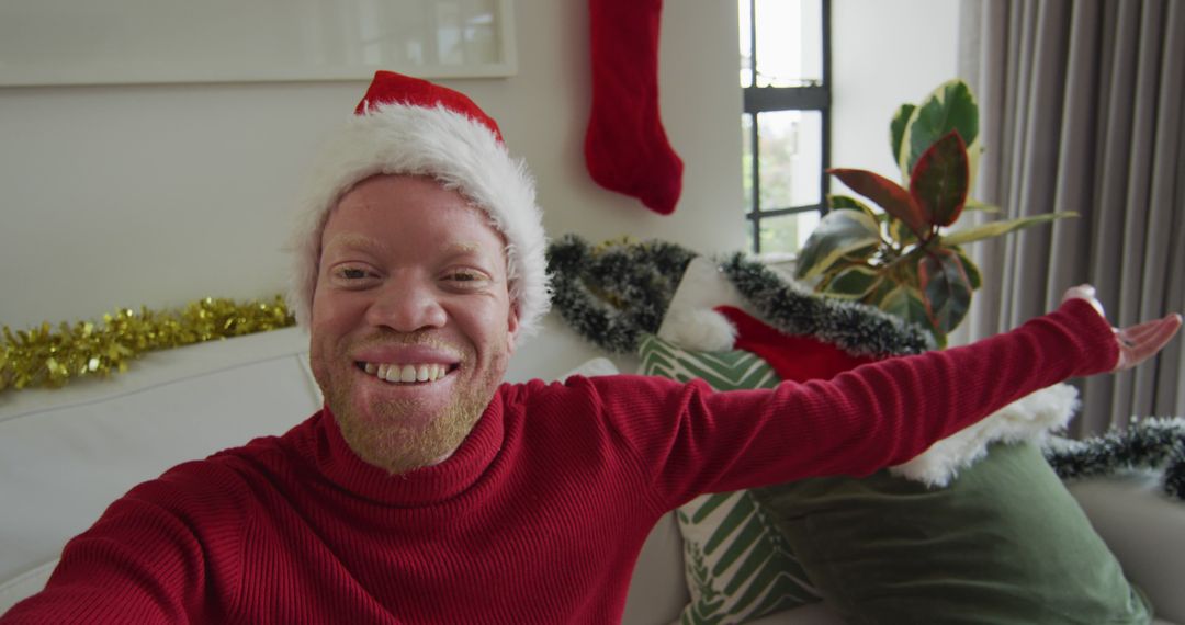 Man with Santa Hat Celebrating Christmas at Home - Free Images, Stock Photos and Pictures on Pikwizard.com