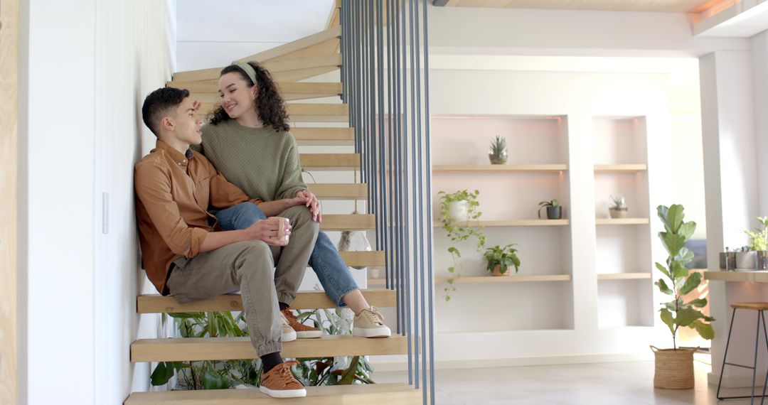 Romantic Couple Relaxing on Modern Staircase Indoors