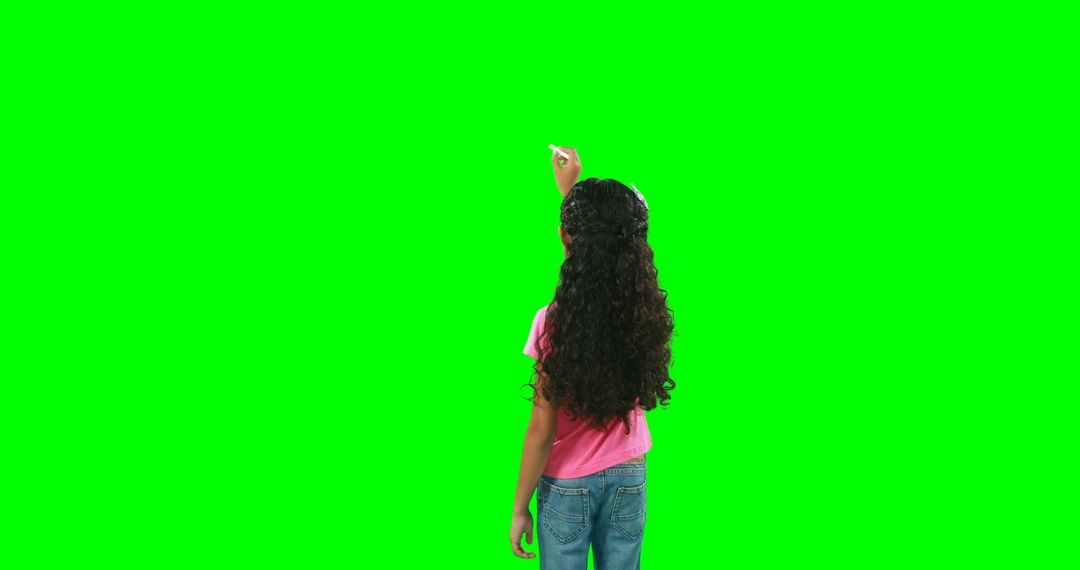 A girl in casual clothes points up in front of a green screen for digital editing. - Free Images, Stock Photos and Pictures on Pikwizard.com