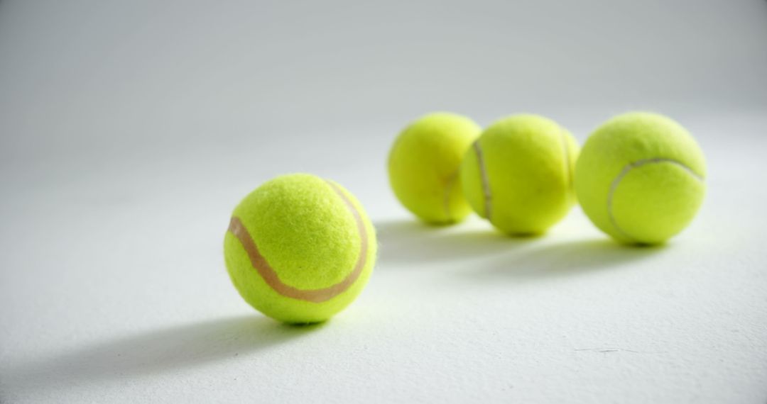 Close-up of Four Tennis Balls on White Surface - Free Images, Stock Photos and Pictures on Pikwizard.com