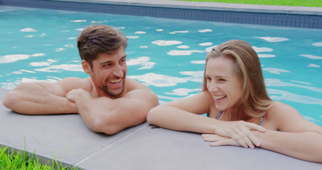 Young Couple Laughing and Relaxing in Pool - Free Images, Stock Photos and Pictures on Pikwizard.com