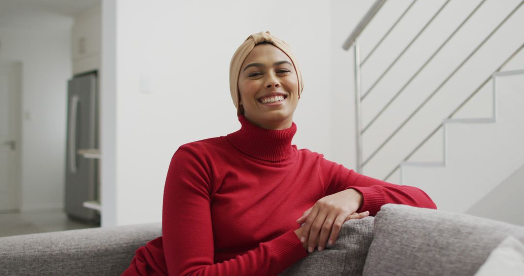 Smiling Young Woman in Red Turtleneck Relaxing on Couch - Free Images, Stock Photos and Pictures on Pikwizard.com