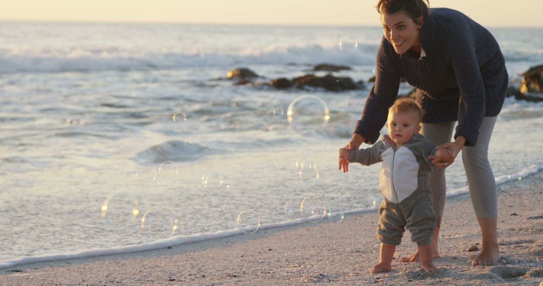 Mother Playing with Toddler on Seaside at Sunset - Free Images, Stock Photos and Pictures on Pikwizard.com