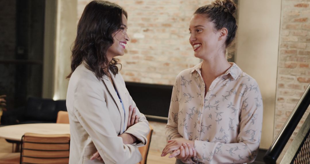 Diverse Female Colleagues in Cheerful Office Discussion