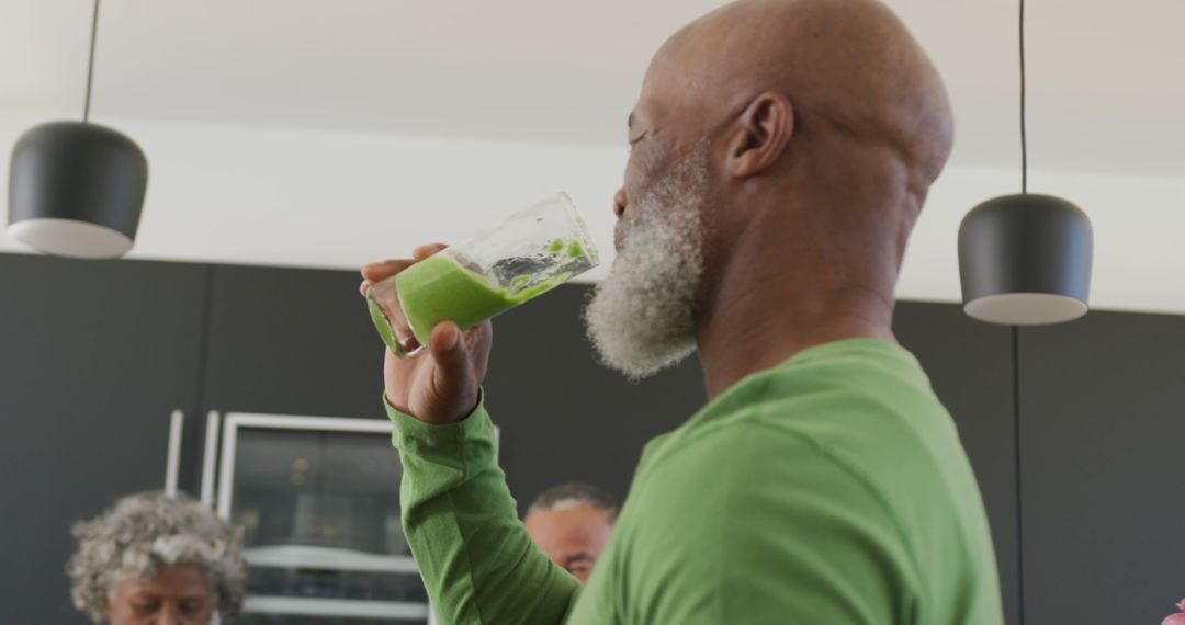 Senior Man Drinking Green Smoothie for Healthy Lifestyle in Modern Kitchen - Free Images, Stock Photos and Pictures on Pikwizard.com