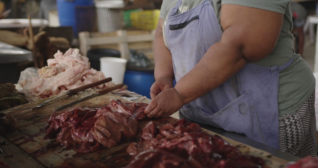 Female Butcher Expertly Cutting Meat in Traditional Market - Free Images, Stock Photos and Pictures on Pikwizard.com