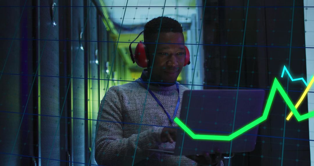 Data Analyst Monitoring Live Financial Graphs in Server Room