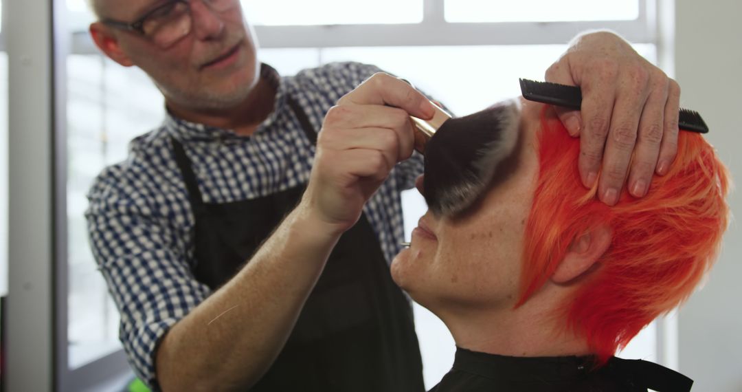 Professional Hairdresser Applying Makeup on Client with Vibrant Red Hair - Free Images, Stock Photos and Pictures on Pikwizard.com