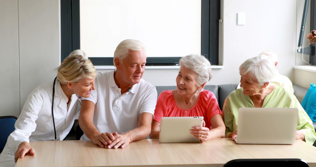 Seniors Using Tablets and Laptops with Supportive Caregiver - Free Images, Stock Photos and Pictures on Pikwizard.com