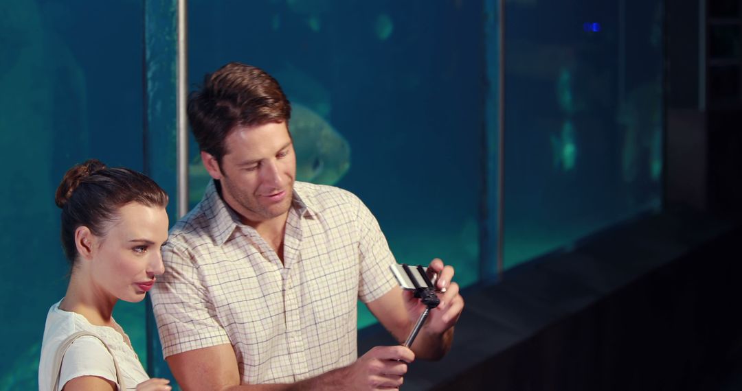 Couple Taking Selfie at Aquarium with Interactive Marine Life