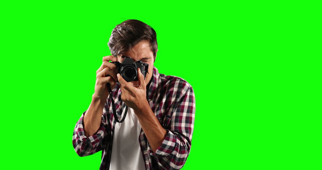 Male Photographer Taking a Photo with Camera on Green Screen Background - Free Images, Stock Photos and Pictures on Pikwizard.com