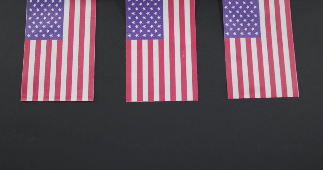 Three United States Flags on Dark Background Representing Patriotism