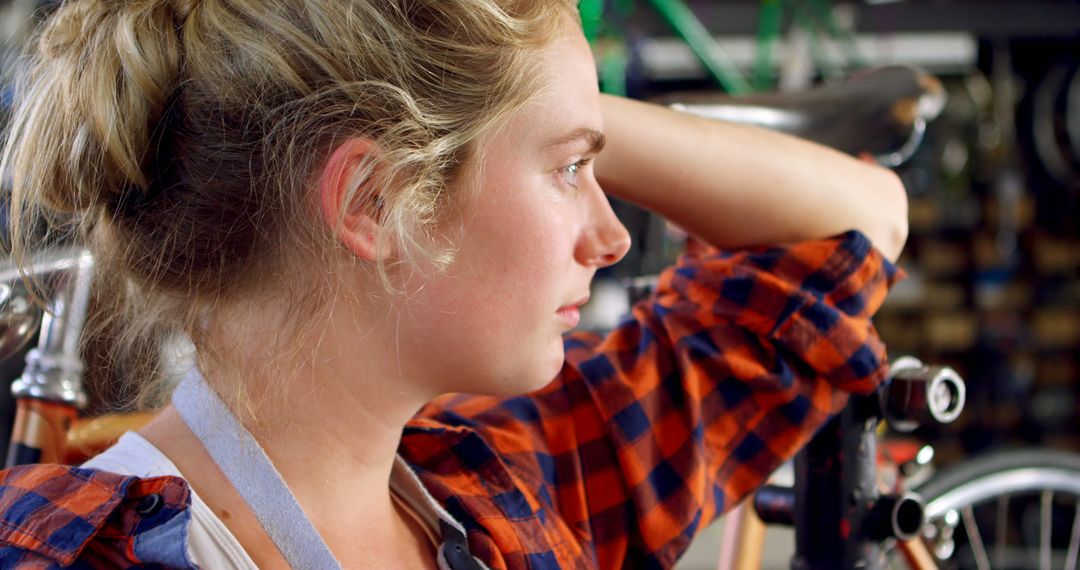 Thoughtful Woman Contemplating Project in Workshop Setting