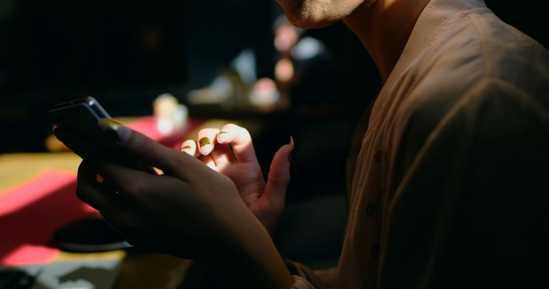 Close-Up of Woman Using Smartphone in Dimly Lit Room - Free Images, Stock Photos and Pictures on Pikwizard.com