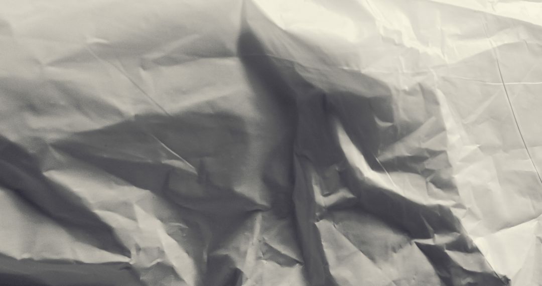 Crumpled White Paper Texture with Subtle Shadows in Monochrome